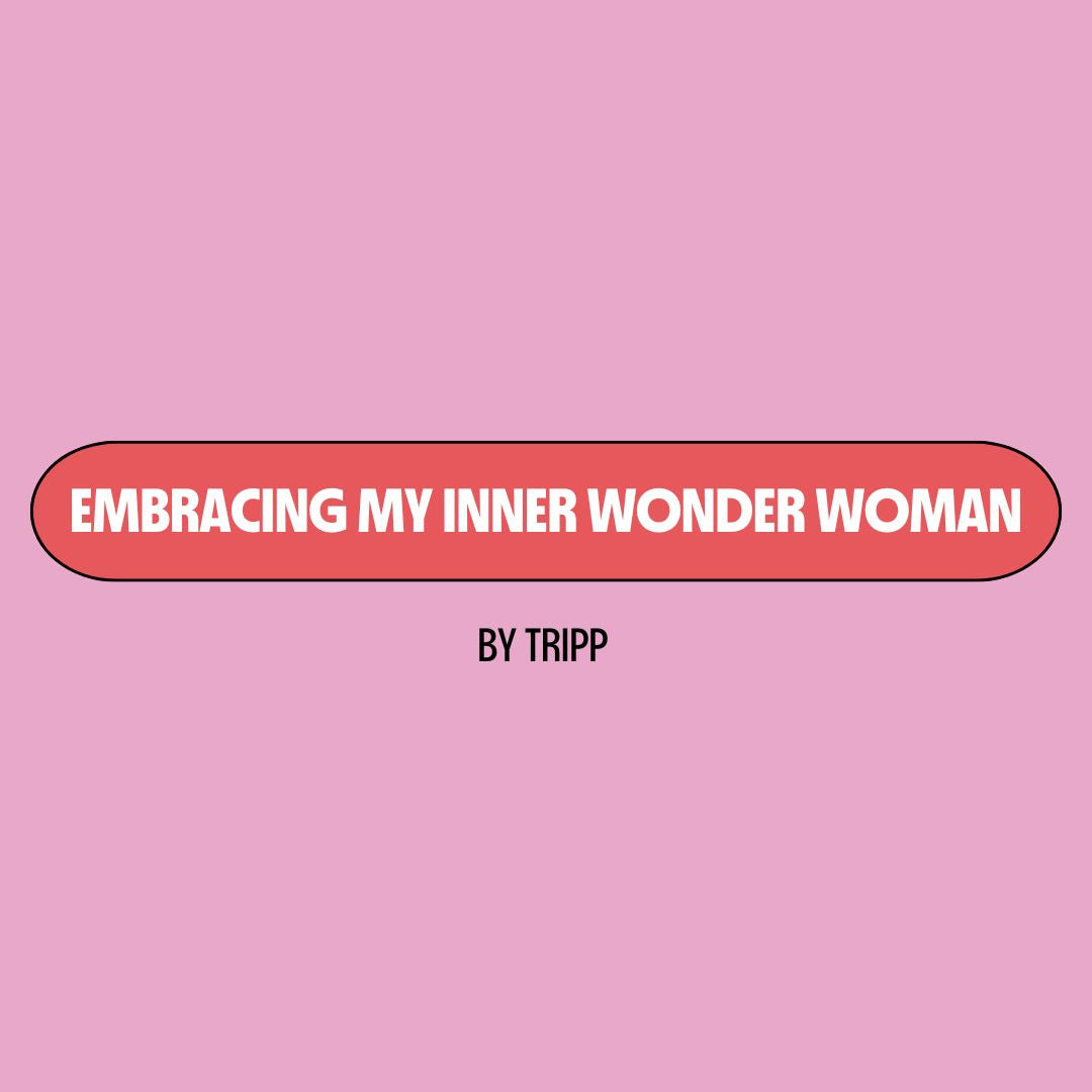 Pink background with a red text box containing writing that reads: "embracing my inner wonder woman." Underneath is black writing that reads: "by Tripp."